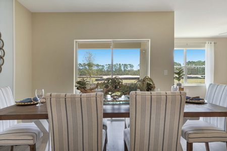 Furnished dining room with view of dining table and windows