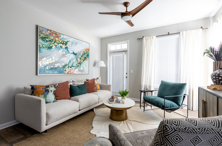 Apartments Near Walmart Supercenter - Preserve at Port Royal - Living Room with Wood-Plank Flooring Ceiling Fan, Window, and Exterior Door to Patio.
