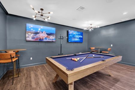 Indoor community area with pool table and tvs