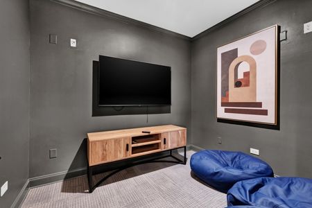 Indoor community lounge area with a tv and bean bags