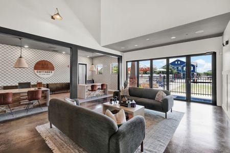Indoor community space with couches and coffee tables with arts on the walls and large windows