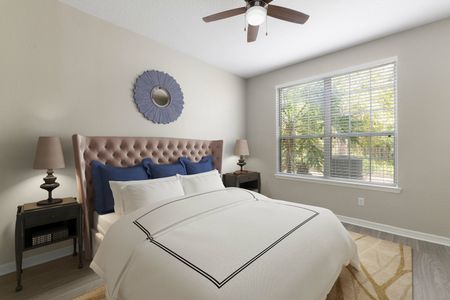 Furnished bedroom with vinyl plank flooring