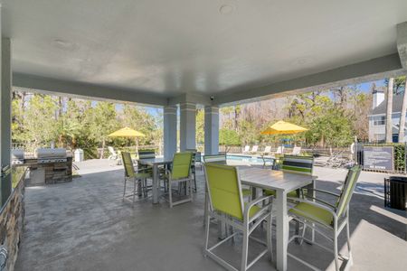 Outdoor patio next to pool and grills