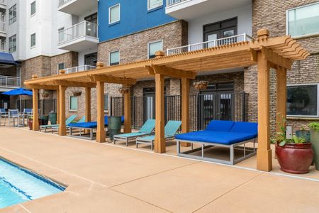 Outdoor poolside cabanas with pool chairs