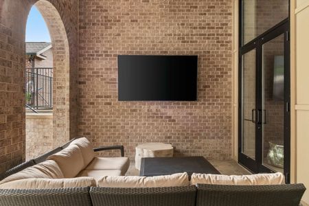 Exterior lounge area with tv and a couch