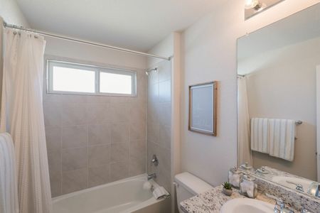 furnished bathroom with shower tub and counter