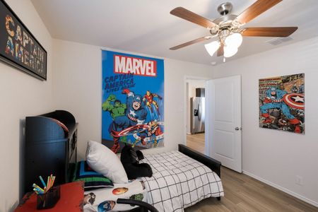 furnished bedroom with poster on wall