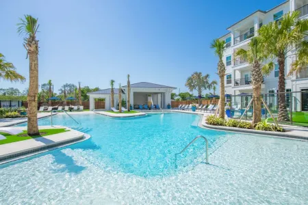 Apartments in Pinellas Park for Rent - Rowan Pointe - Large Resort-Style Pool Surrounded By Lounge Seating and Covered Lounge Area by Pool
