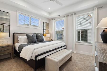 furnished bedroom with bed and windows in home