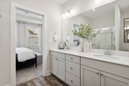 furnished bathroom with double sink vanity in home