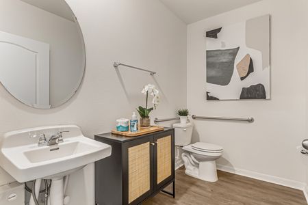 Bathroom with one sink and round mirror above it