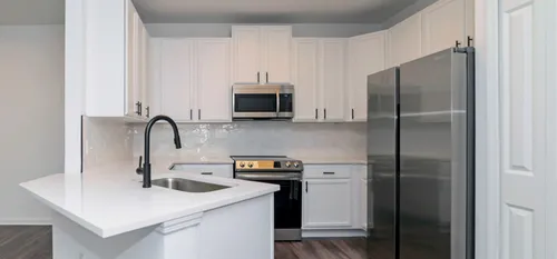 unfurnished kitchen with stainless steel appliances and wood cabinets