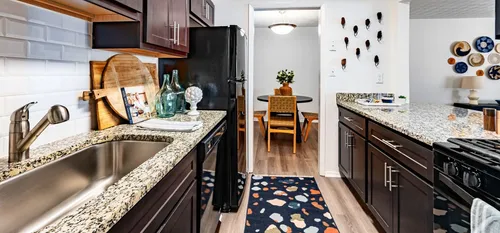 Kitchen with wooden cabinets and black appliances