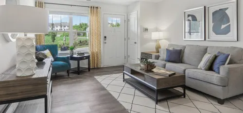 Furnished living room with couch, coffee table and window