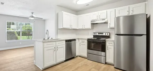 furnished leasing office with seating, kitchen area and tables