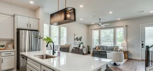 furnished and decorated living room and kitchen with wood style flooring