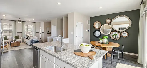 furnished living and kitchen area in townhome