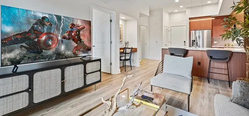 stylish decorated living room and kitchen with custom cabinets