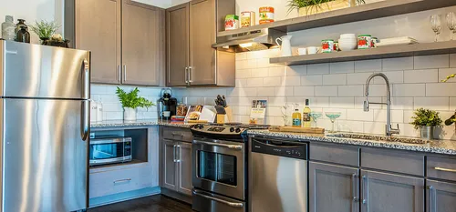 Kitchen interior with stainless steel appliances and open shelving