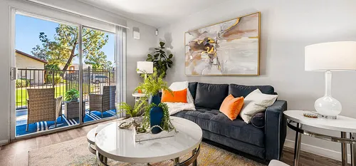 decorated living area sliding glass doors to back patio