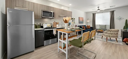 furnished kitchen and living area in apartment home