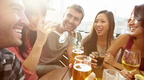 group of people drinking around table