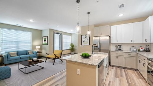 Chic open-concept living and kitchen area with modern furnishings and natural light.