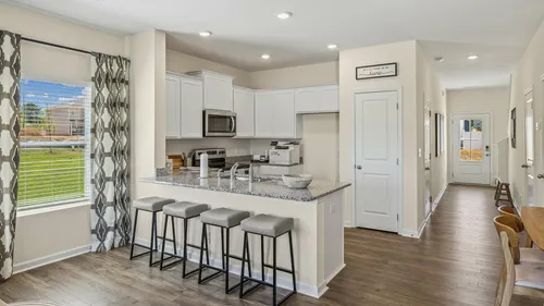 Townhome kitchen with white cabinets