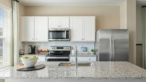 Kitchen with white cabinets and large island at The Meadows at Berkeley Ridge in Martinsburg, WV