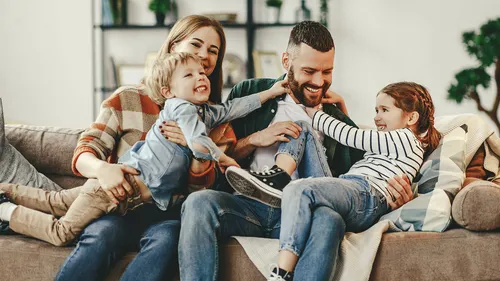 Family hugging on a couch