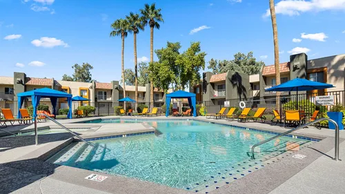 sparkling pool with shaded cabanas