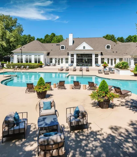 clubroom building and exterior pool with furniture on sunny day