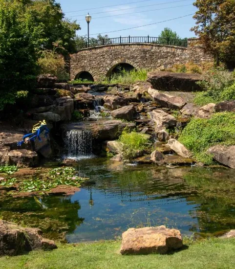 stream with bridge on sunny day