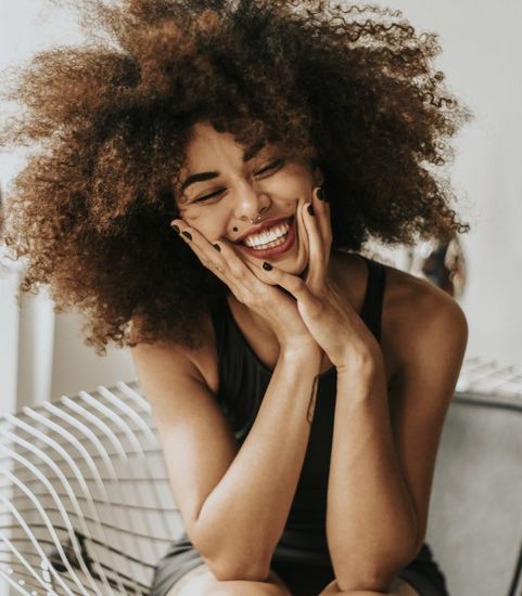 woman sitting down and smiling