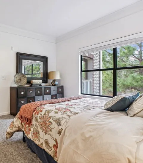 Bedroom with ceiling fan and window