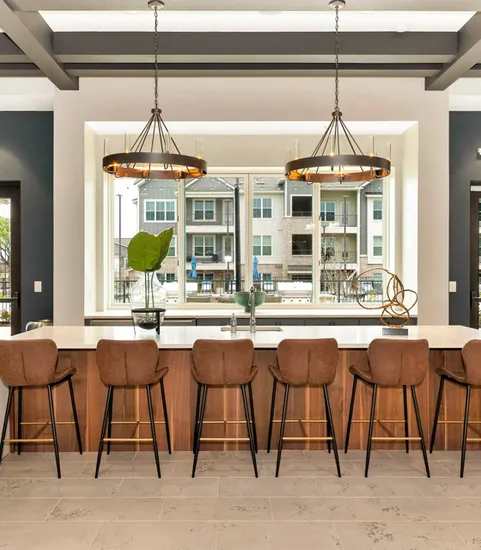 furnished kitchen shot with counter stools and ceiling lights