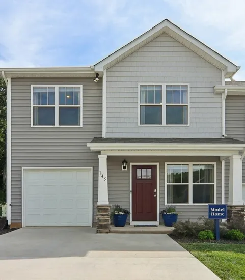 Exterior of community with green grass and driveways in the daytime