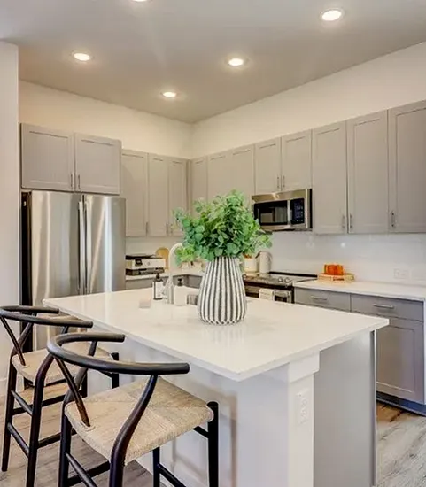 Furnished kitchen with island and grey cabinets