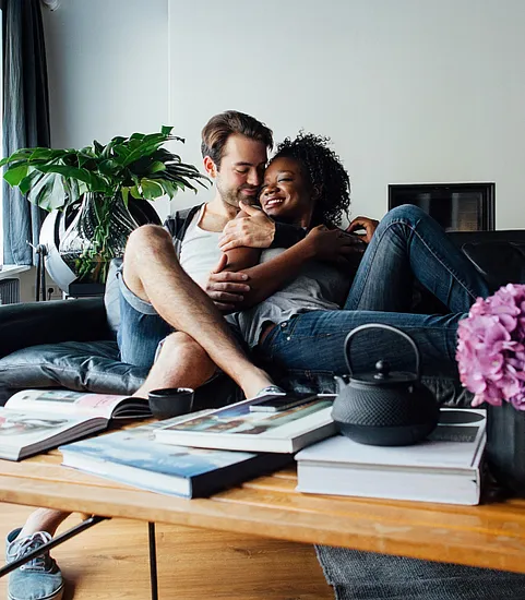 Couple cuddling on a couch