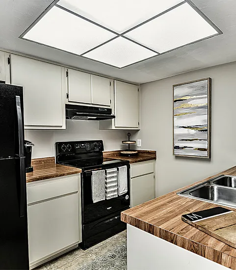 Kitchen with white cabinets and wood countertops