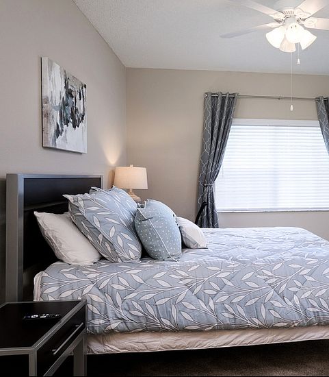 Guest bedroom with bed and TV