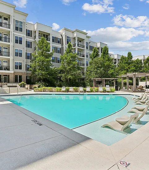 pool with apartment building at nighttime
