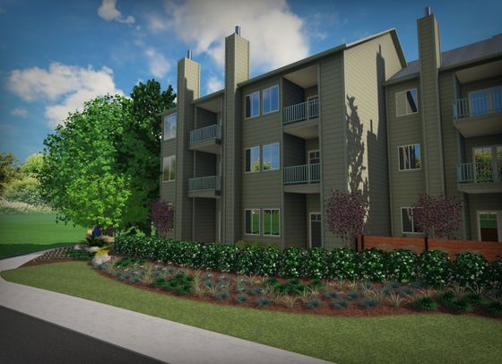 Exterior of The Finch apartments in Vancouver, WA, with beige siding, private balconies, and tall evergreen trees nearby.