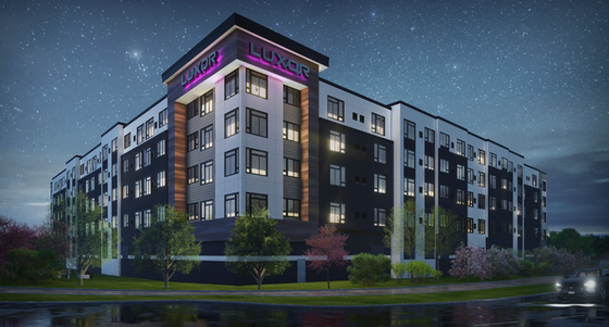 Modern luxury apartment building, elegantly lit under a starry night sky, showcasing sleek architectural design.
