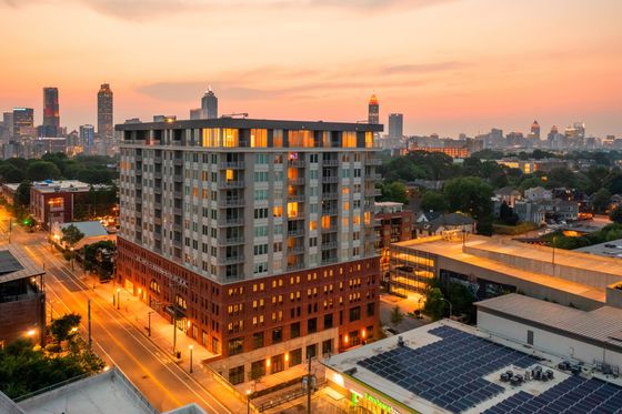 high rise apartment building with atlanta skyline