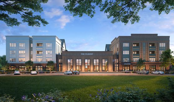 Elegant apartment building exterior with modern design and lush landscaping.