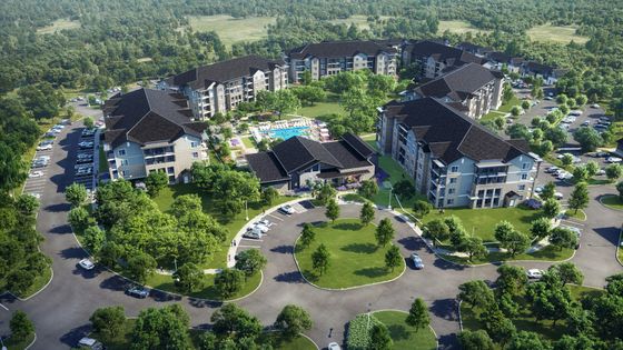 Aerial view of a luxurious residential complex surrounded by lush greenery, featuring multiple apartment buildings, parking lots, and a central swimming pool area.