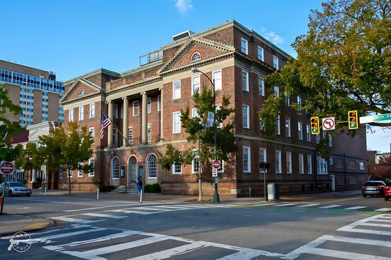 Charming historic brick building with architectural columns and arched windows.
