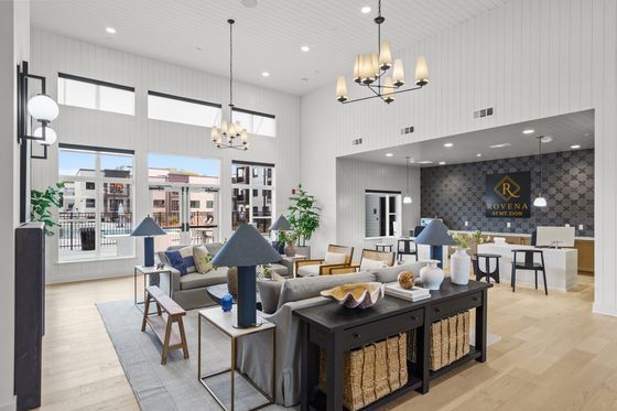 Elegant, spacious lobby at Rovena at Mt. Zion featuring modern decor, natural light, and comfortable seating overlooking a serene outdoor view.