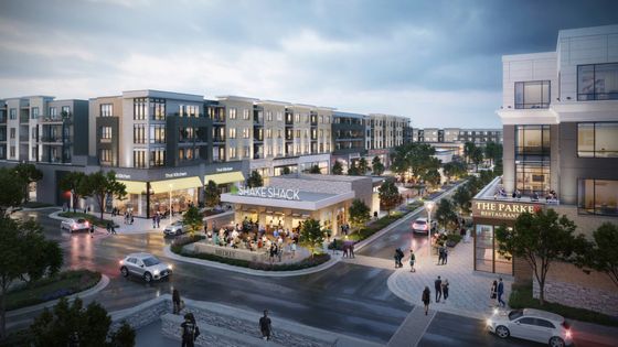 Vibrant urban complex featuring modern apartments, trendy restaurants, and bustling streetscape at dusk, showcasing a lively community atmosphere.